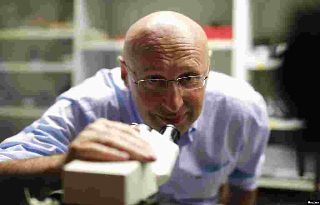 Chemistry Nobelist Stefan Hell poses with a nanoscale microscope at the Max Planck Institute for Biophysical Chemistry in Goettingen, Germany, Oct. 8, 2014.