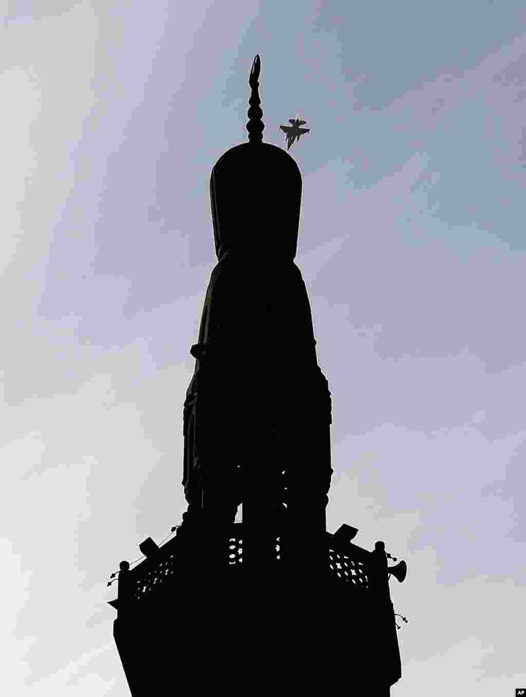 An Egyptian jet fighter flys over Tahrir Square as protesters gather, not pictured, in Cairo, December 9, 2012.