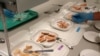 Trout samples at the Washington State University School of Food Science. Alternative feeds resulted in slightly different colors and textures in trout fillets. (VOA/T. Banse)