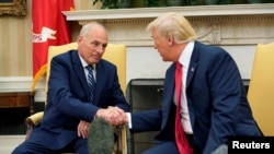 FILE - President Donald Trump shakes hands with John Kelly after the latter was sworn in as White House chief of staff in the Oval Office in Washington, July 31, 2017.