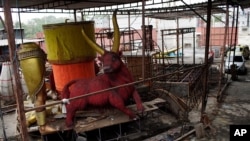 Carnival parade floats sit unfinished in the Unidos de Padre Miguel samba school workshop, in Rio de Janeiro, Brazil, Sept. 21, 2020.