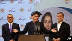 Afghan President Ashraf Ghani, center, speaks at the Afghan Independent Election Commission after receiving the official certificate of winning a 2nd term as president, in Kabul, Feb. 19, 2020. 