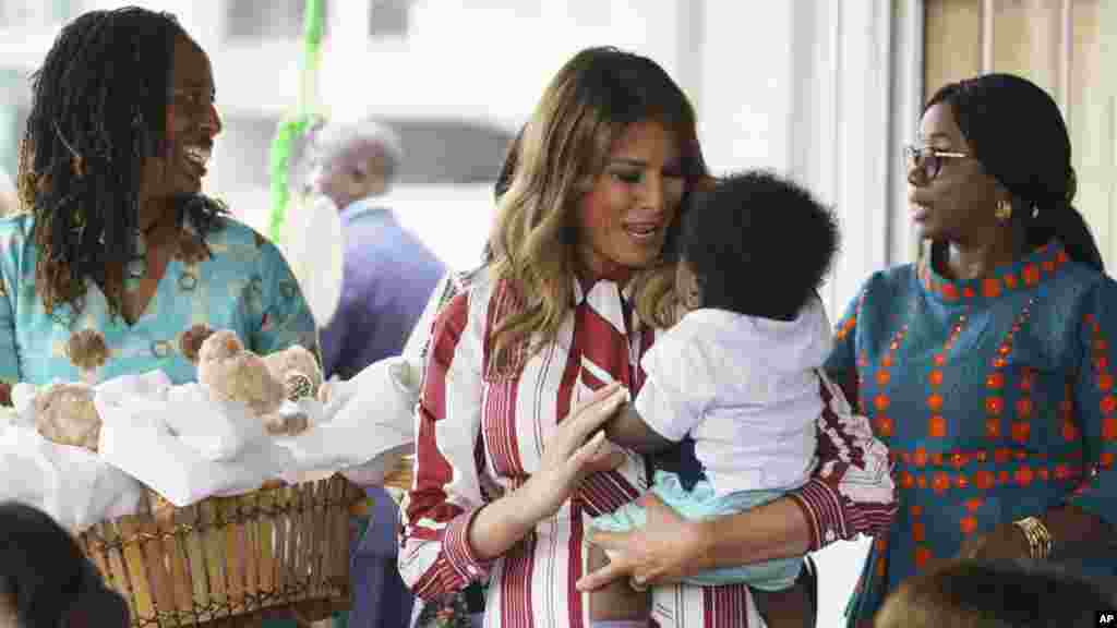 First lady Melania Trump holds a baby as she visits Greater Accra Regional Hospital in Accra, Ghana, Oct. 2, 2018.