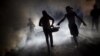 FILE - A worker of the Ministry of Public Health and Population fumigates in the street against mosquito breeding to prevent diseases such as malaria, dengue and Zika in Port-au-Prince, Haiti, Feb. 15, 2016.