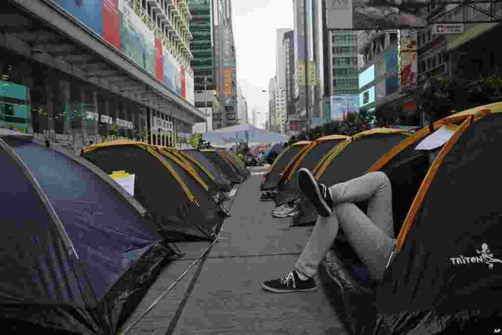 A protester rests in his tent near a main road in the Mongkok district, Hong Kong, Oct. 15, 2014.