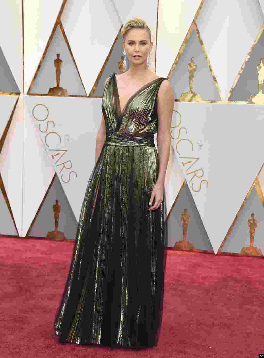 Charlize Theron arrives at the Oscars on Sunday, Feb. 26, 2017, at the Dolby Theatre in Los Angeles.