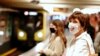 Passengers with face masks wait for a train at the Alexanderplatz underground station in Berlin, Germany, April 27, 2020. 