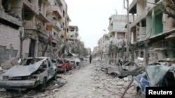 The damaged cars and buildings are seen in the besieged town of Douma, Eastern Ghouta, Damascus, Syria February 25, 2018.