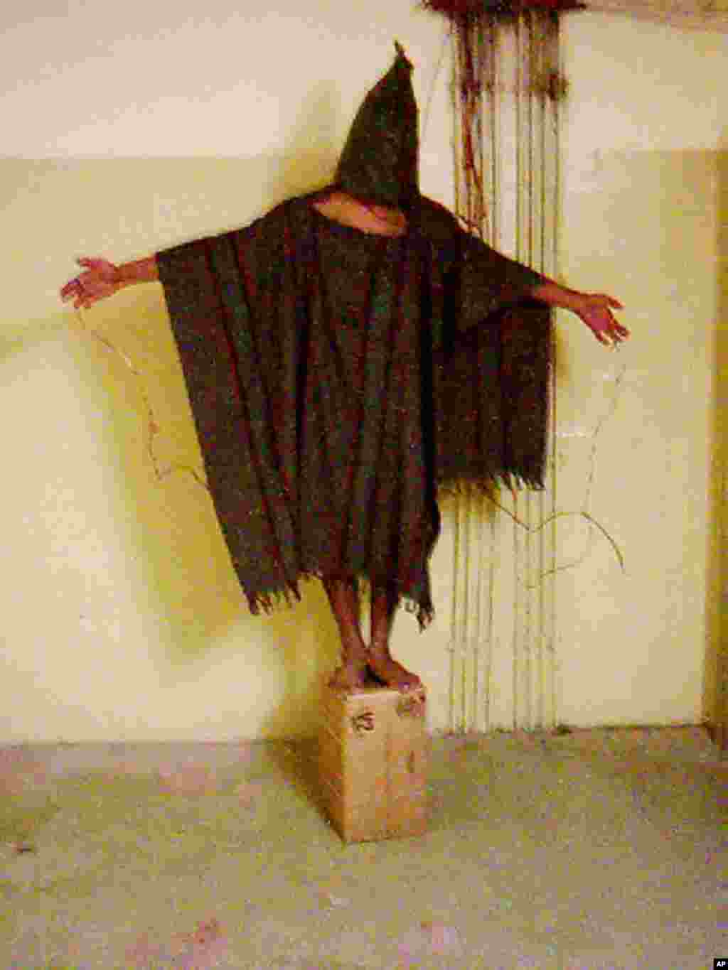 This image obtained by The Associated Press shows an unidentified detainee standing on a box with a bag on his head and wires attatched to him in late 2003 at the Abu Ghraib prison in Baghdad, Iraq.