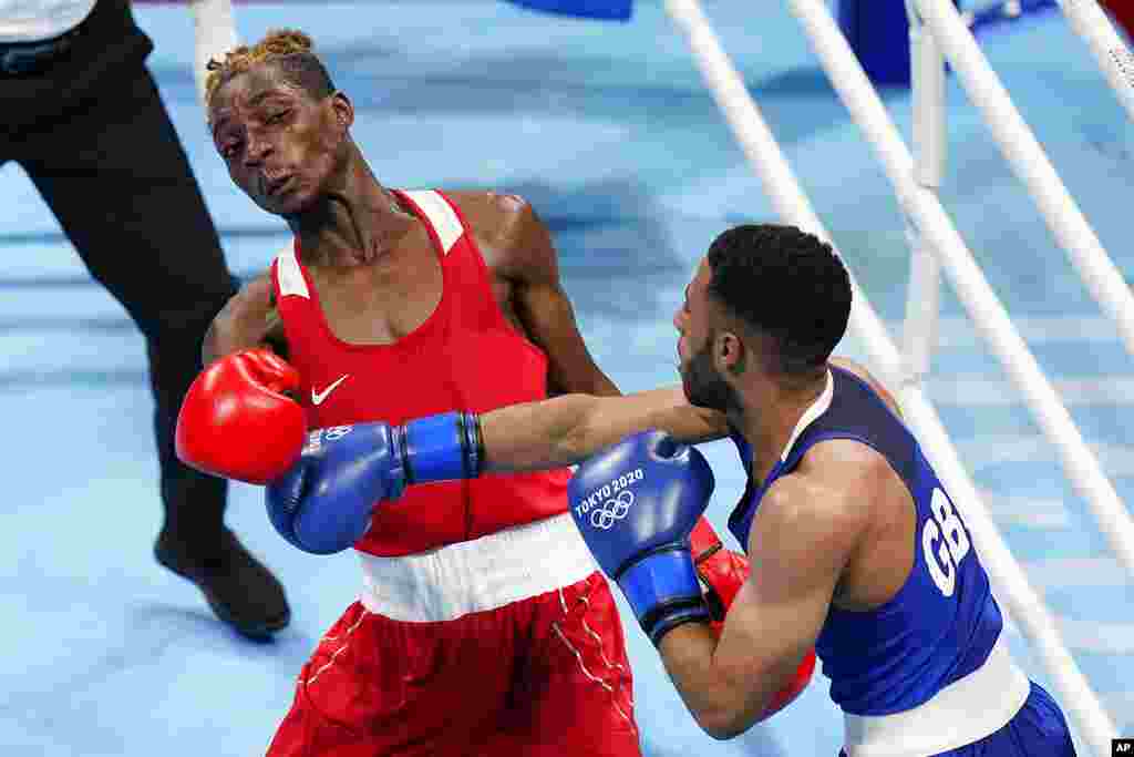 Zambia's Patrick Chinyemba, left, exchanges punches with Britain's Galal Yafai during their men's flyweight 52-kg boxing match at the 2020 Summer Olympics, Saturday, July 31, 2021, in Tokyo, Japan. (AP Photo/Frank Franklin II)