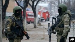 FILE - Russian special forces soldiers wear masks during an anti-terrorist operation in Makhachkala, Dagestan, Russia, Jan. 20, 2014. Dagestan province in the North Caucasus has been feeding hundreds of fighters to the Islamic State in Syria, officials say.