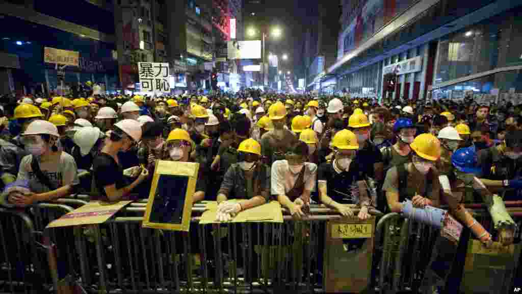 Protesters stand guard behind a barricade at the occupied area in the Mong Kok district of Hong Kong, Oct. 20, 2014.