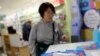 Protection class FFP2 respirator masks are seen inside a pharmacy as a tourist looks at them, amid the novel coronavirus outbreak, in Barcelona, Spain, Feb. 4, 2020.