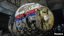 The reconstructed wreckage of the MH17 airplane is seen after the presentation of the final report into the crash in July 2014 of Malaysia Airlines flight MH17 over Ukraine, in Gilze Rijen, the Netherlands, October 13, 2015. 