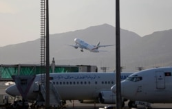 FILE - A plane takes off from Hamid Karzai International Airport in Kabul, Afghanistan, July 4, 2021.