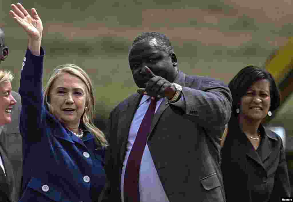 Hillary Clinton is met by Uganda's Foreign Affairs Minister Okello Oryem upon arrival at Entebbe International Airport, August 3, 2012.
