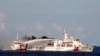 FILE - Image released by Vietnam Coast Guard, a Chinese coast guard vessel, right, fires water cannon at a Vietnamese vessel off the coast of Vietnam. 