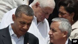 President Barack Obama, left, talks to Guatemala's President Otto Perez at the sixth Summit of the Americas in Cartagena, Colombia, Sunday April 15, 2012.