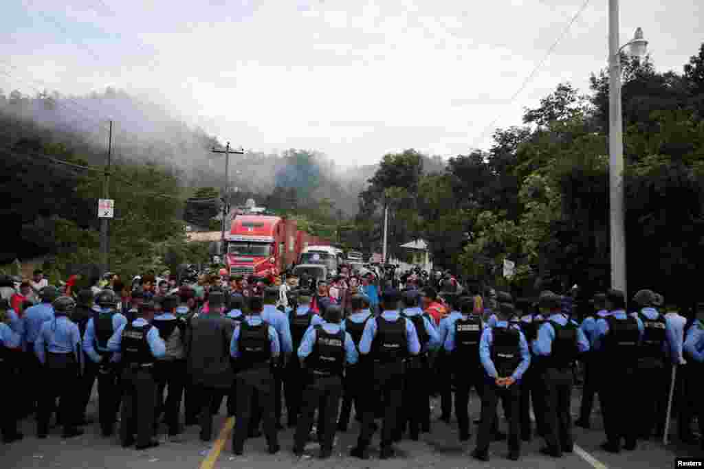 Honduran police officers block the access to the Agua Caliente border with Guatemala as Honduras' migrants try to join a migrant caravan heading to the U.S., in the municipality of Ocotepeque, Honduras, Oct. 19, 2018.
