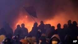 Protesters clash with police in central Kyiv, Ukraine, early Monday, Jan. 20, 2014.