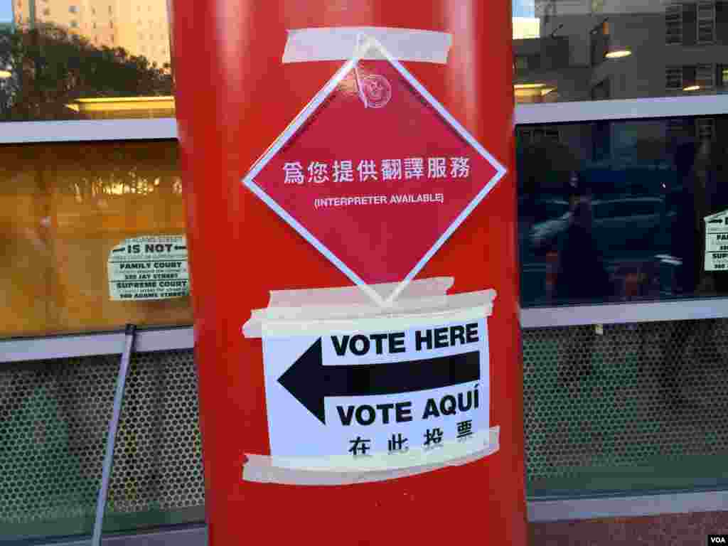 Voting directions in various language are seen on a poll in Manhattan, NY, Nov. 8, 2016. (Photo: R. Taylor / VOA)