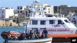 An Italian Coast Guard boat approaches a boat of refugees off Lampedusa, March 2, 2011 (file photo).