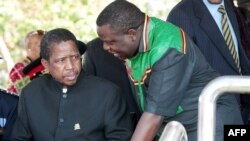 FILE - Then-Acting President Edgar Lungu, left, talks to foreign affairs minister Harry Kalaba during festivities marking Zambia's 50th anniversary of independence, Oct. 24, 2014. 