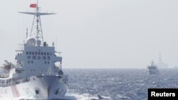 FILE - Ships of Chinese Coast Guard are seen near Chinese oil rig Haiyang Shi You 981 in the South China Sea, about 210 km (130 miles) off shore of Vietnam.