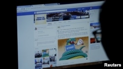 FILE PHOTO: An internet user looks at a Facebook page in Hanoi, Dec. 30, 2015.