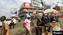 People walk on the street around Kwame Nkrumah circle in Accra, Ghana, Dec. 2, 2016.
