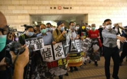 In this file photo taken on Nov. 3, 2020 pro-democracy activists demonstrate outside the West Kowloon court in Hong Kong.