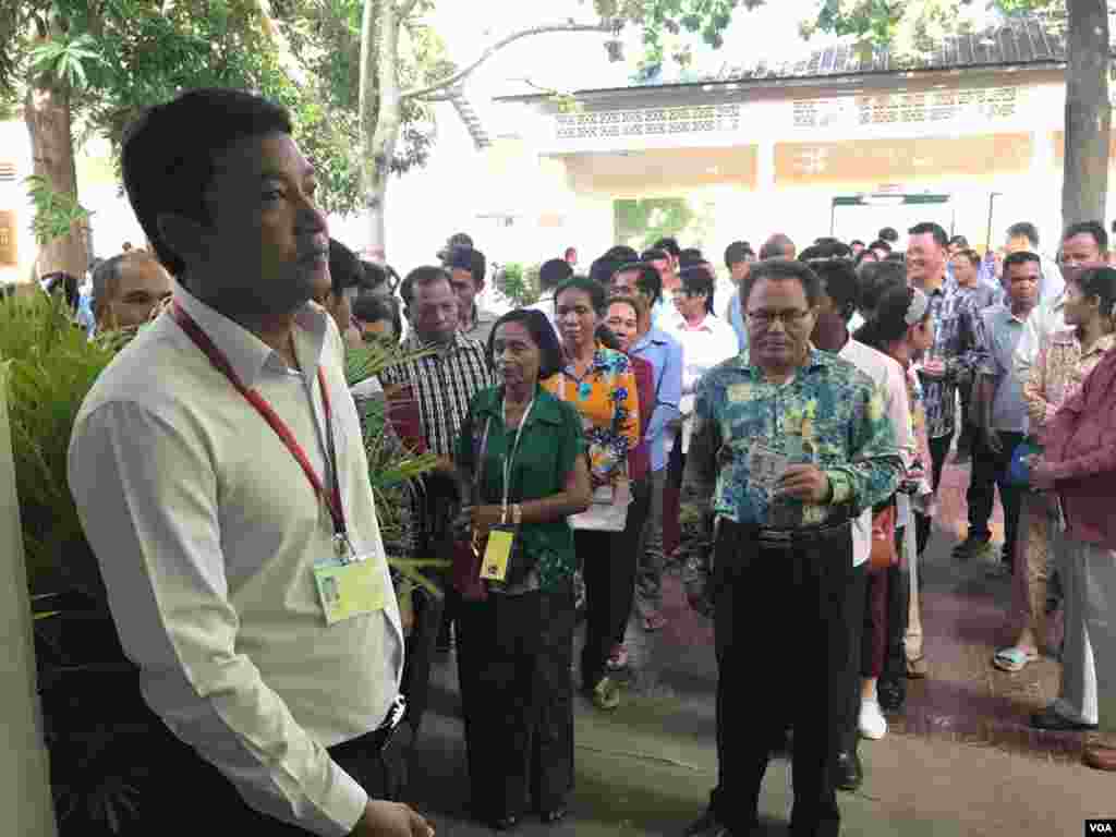 ពលរដ្ឋកម្ពុជាតម្រង់ជួររង់ចាំបោះឆ្នោតនៅការិយាល័យបោះឆ្នោតមួយកន្លែងក្នុងក្រុងតាខ្មៅ ខេត្តកណ្តាល កាលពីព្រឹកថ្ងៃអាទិត្យ ទី២៩ ខែកក្កដា ឆ្នាំ២០១៨។ (នៅ វណ្ណារិន/VOA)