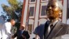 South African President Jacob Zuma (second l) talks with Mandla Mandela (l) after they and other dignitaries unveiled a bust of former South African President Nelson Mandela (r) at the South African Parliament in Cape Town, South Africa, April 28, 2014.