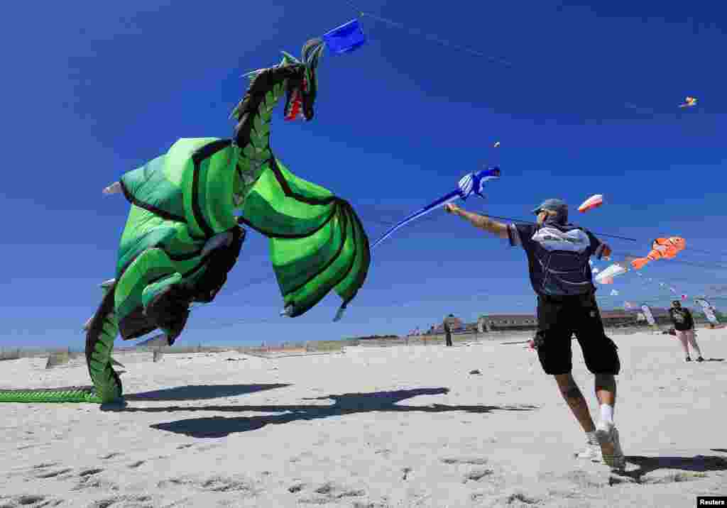 Tony Jetland, a U.S. citizen, holds his kite's strings during a practice run at Dolphin Beach ahead of this weekend's 30th Cape Town International Kite Festival in Cape Town, South Africa.