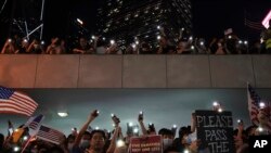 Protestors light their torches during a peaceful rally in central Hong Kong's business district, Oct. 14, 2019. 