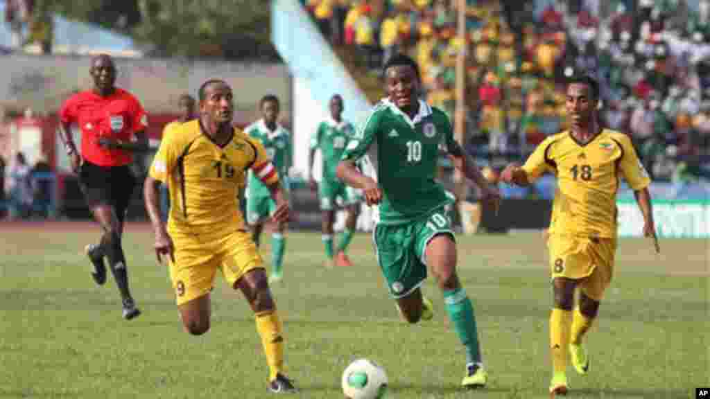 Nigeria's Mikel John Obi, centre, challenges for the ball with Ethiopia's Adane Girma left, and Shemeles Bekele, right, during their 2014 World Cup qualifying playoff match.