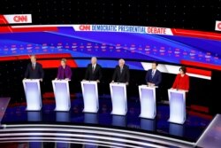 Democratic presidential candidates stand on stage during a Democratic presidential primary debate hosted by CNN and the Des Moines Register in Des Moines, Iowa, Jan. 14, 2020.