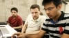 FILE - Shiva Gopalan, a computer engineering masters student at Texas A&M University (far right), confers with IBM developers Henrique Copelli Zambon (center) and Luiz Aoqui, during an IBM hosted Spark Hackathon at Galvanize, a tech hub in San Francisco, June 14, 2015.