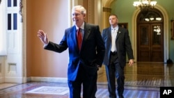 Senate Minority Leader Mitch McConnell walks to his office on Capitol Hill, Nov 12, 2014.