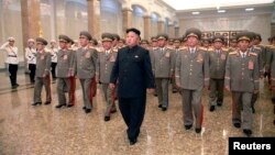 North Korean leader Kim Jong Un (C) visits the Kumsusan Palace of the Sun at midnight on Tuesday on the occasion of the 20th anniversary of the demise of President Kim Il Sung in this photo released by North Korea's Korean Central News Agency (KCNA) in Py