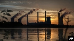 FILE - The coal-fired Plant Scherer operates in Juliette, Ga., June 3, 2017. A lawsuit filed Monday on behalf of two children challenges Trump administration efforts to scrap a package of pollution-reduction rules known as the Clean Power Plan.