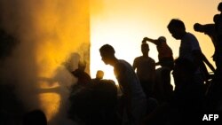 گروهی از فلسطینی‌ها در تلاش هستند تا قربانیان را از زیر آوار خارج کنند. عکس مربوط به منطقه خان‌یونس است.