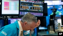 Un trader se tient la main sur la tête après l'arrêt de la négociation à la Bourse de New York, le 18 mars 2020. (Photo: AP)