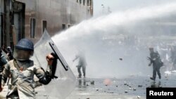 Afghans throw stones toward security forces during a protest in the wake of Wednesday's deadly bombing, in Kabul, Afghanistan, June, 2, 2017. 