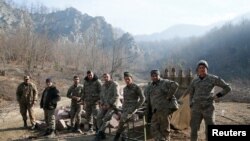 Ethnic Armenian soldiers are seen in the village of Knaravan located in a territory which is soon to be turned over to Azerbaijan under a peace deal that followed the fighting over the Nagorno-Karabakh region, Nov. 15, 2020. 