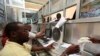 FILE - Workers serve customers at a money transfer office in Soobe village, southern Mogadishu, Somalia, May 8, 2013.