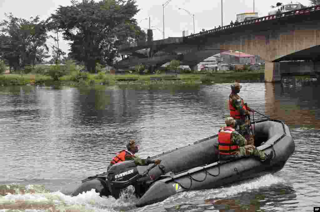 Liberian soldiers patrol the seaside of West Point a area that has been hit hard by the Ebola virus, with local residents not allowed to leave the West Point area, as government forces clamp down on movement to prevent the spread of Ebola, in Monrovia,