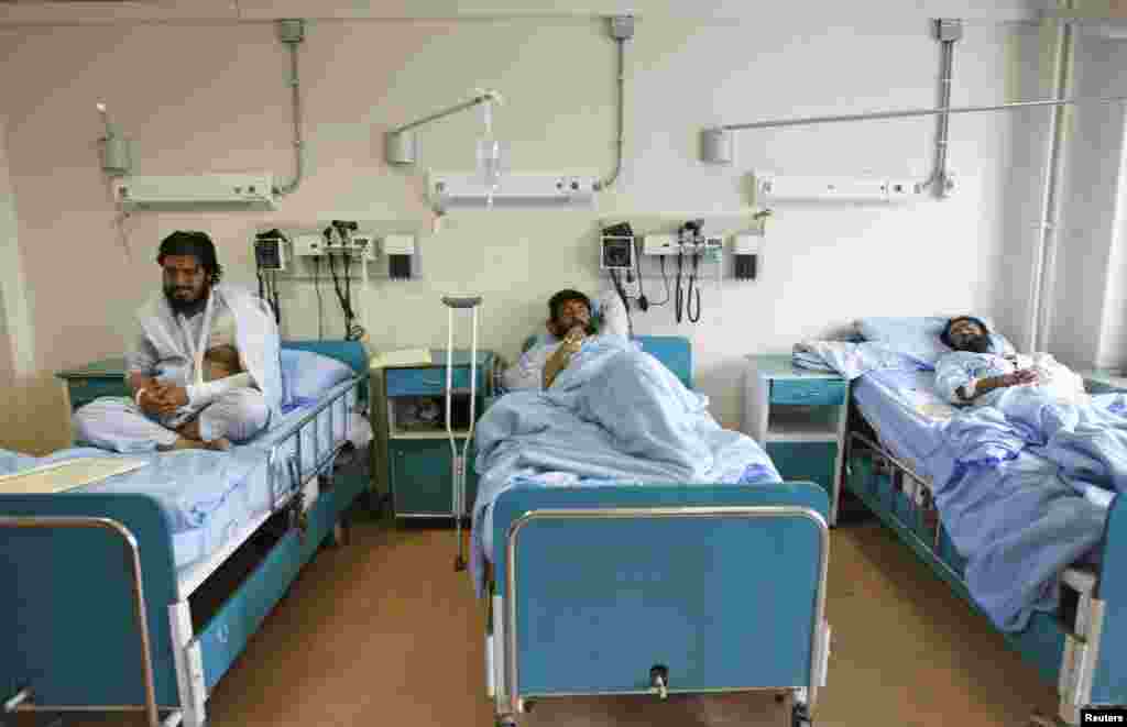 Men receive treatment at a military hospital in Kabul after being wounded during a suicide attack at a volleyball match on Sunday in the Yahya Khel district of Paktika province, Nov. 24, 2014.