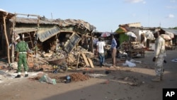 People gather at the site of a suicide bomb attack at a market in Maiduguri, Nigeria, June 22, 2015.