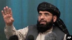 Suhail Shaheen, member of negotiation team gestures while speaking during a joint news conference in Moscow, March 19, 2021.